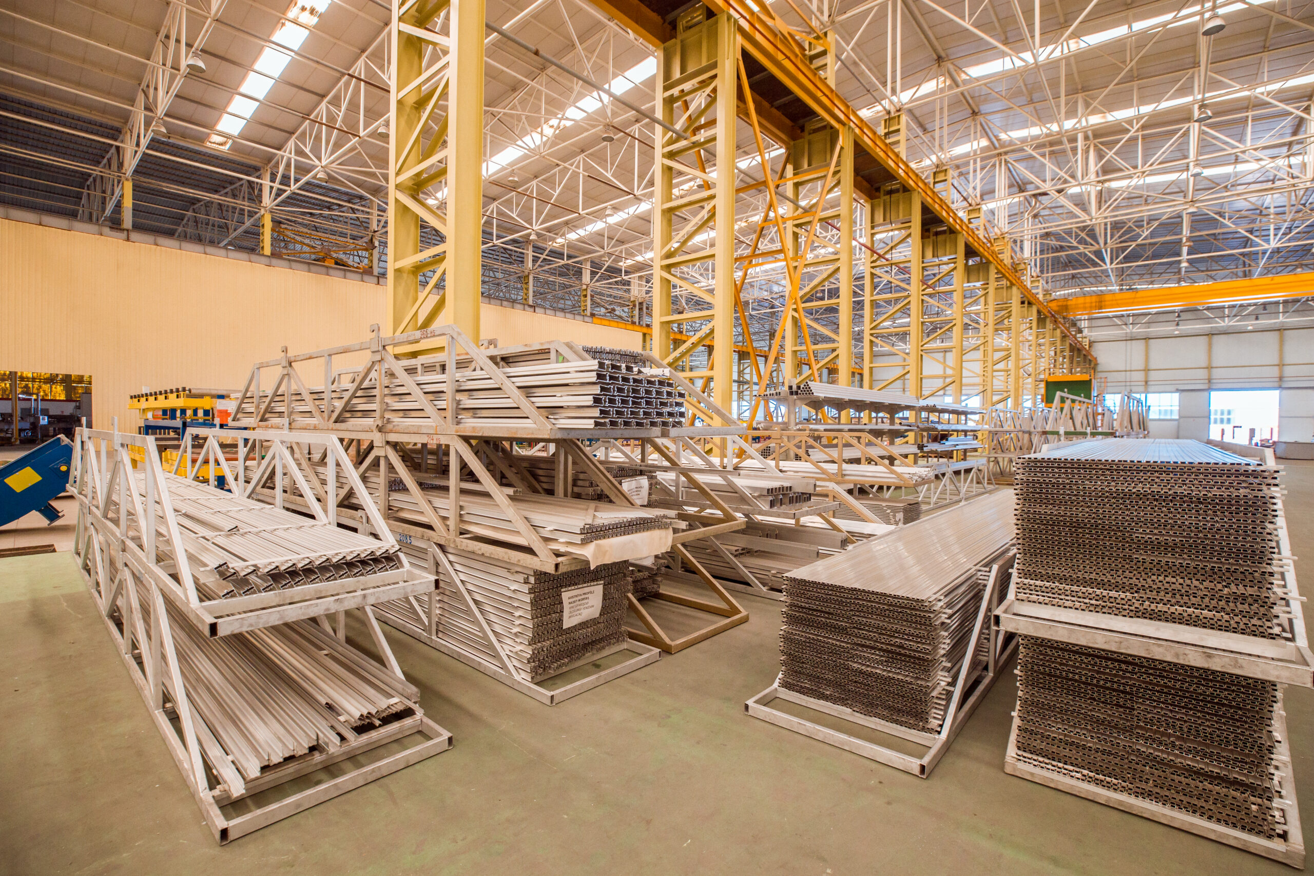 Estrutura de um grande galpão metálico em fase final de montagem em uma área industrial de Curitiba.